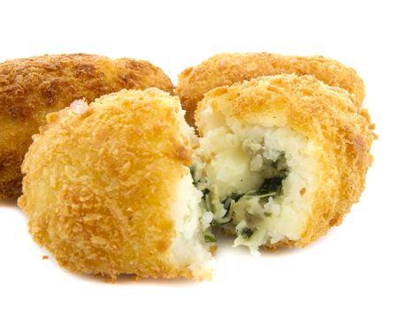 Three croquettes on white background with one is cutting 