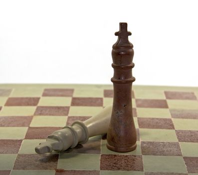 fallen king on the marble chess board