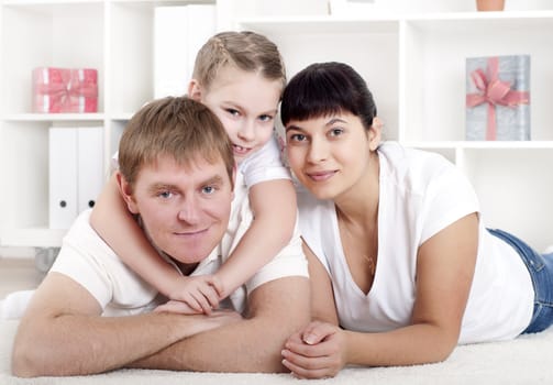 Portrait of happy family lying together, hugging and happy