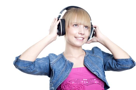 Young attractive woman listing to music with headphones against white background