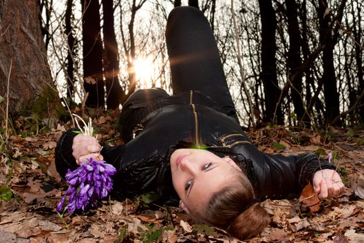 beautiful girl with snowdrops in a forest