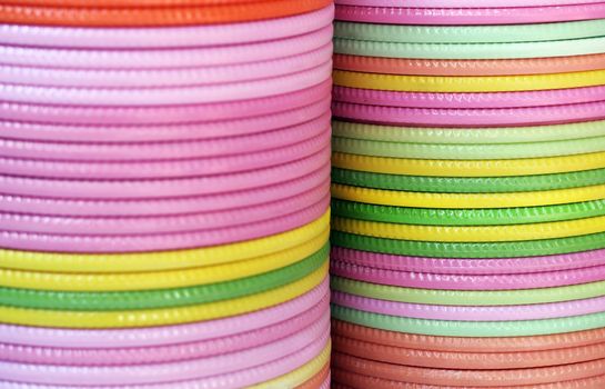 Plates of various colors piled on one above the other