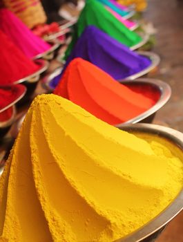 Colorful piles of powdered dyes used for holi festival on display in an indian shop at mysore