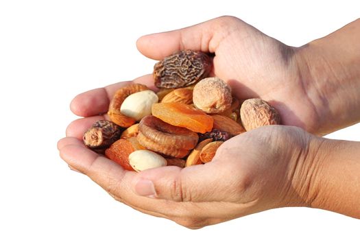 Bunch of dry fruits in a woman's hand. Dry fruits like almonds, raisins, dates and apricots isolated on white