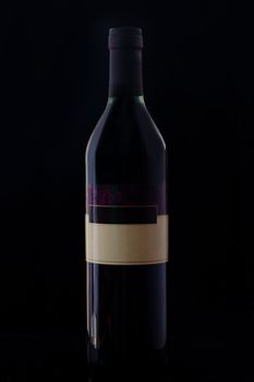 The wine bottle on the dark background.