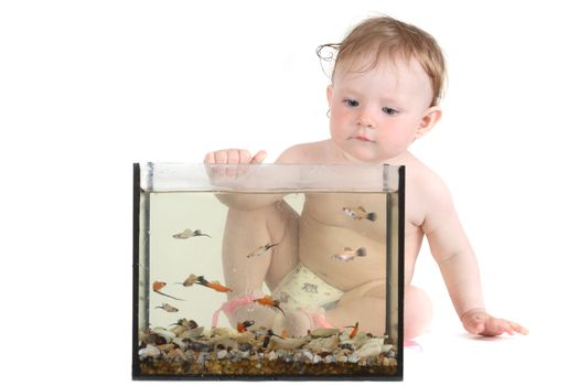 the little blue-eyed girl plays with small fishes in an aquarium. option 3