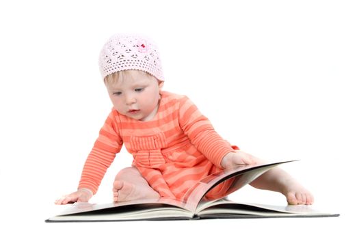 The little blue-eyed girl thumbs through the book. A portrait on a white background. Option 4