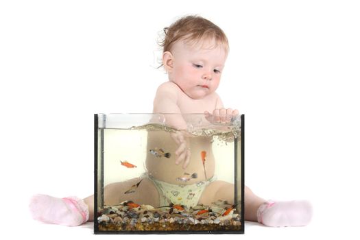 the little blue-eyed girl plays with small fishes in an aquarium. option 1
