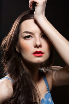 The portrait of sensual young woman on dark background