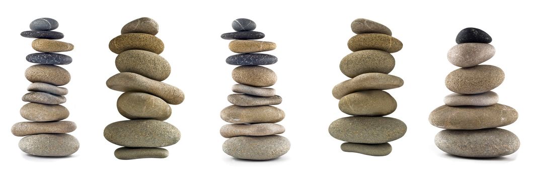Collection of Balanced stone stacks or towers isolated over white