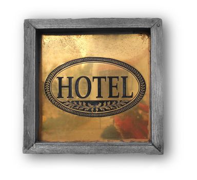 Hotel wooden plaque on a white wall with hotel word on golden colored sheet 