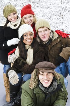 Group of young friends having fun outdoors in winter