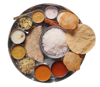 Traditional indian lunch food and meals with rice, phulka, puri, curries and sweets isolated on white