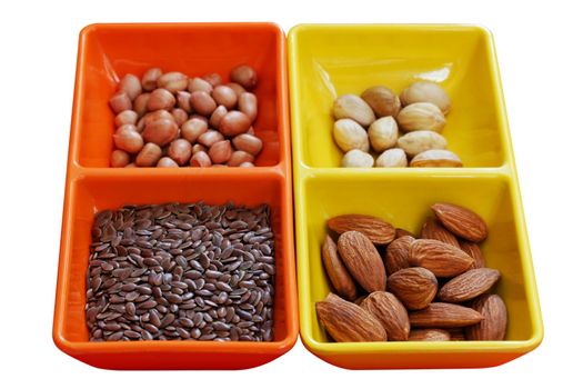 Dry fruit seeds - almond, pistachio, peanut and flaxseed in colorful containers