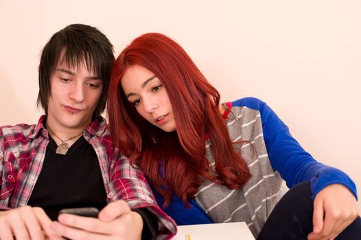 Student couple looking at something on a smarthphone