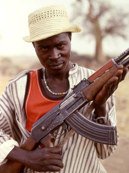 Nuba Mountains, Sudan - January 13  2008: a fighter of the Sudanese Nuba tribe with his Kalashnikov. Since 1991, the Nuba fought alone without supplies, depending solely on local support. Thousands of young Nuba have left for the South, risking their lives