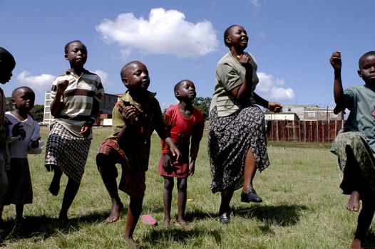 Nairobi,Kenya January 10,2009.Street children play happily in a park.There are many street children in Nairobi.The association Resque Dada was born in Nairobi retrieves them through the streets of the capital to give it a decent life