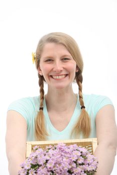 Portrait of smiling woman with pink flowers on white background