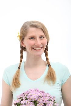 Studio shot of smiling blonde with pink flowers on white background