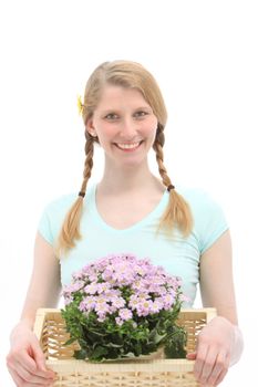 Studio shot of attractive young female who is holding flowers on white background