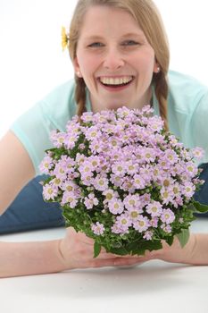 Smiling woman holding a bouquet of pink flowers