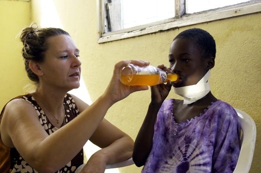 Beira, Mozambique -January 10,2010:Swiss woman,Barbara Hofmann,helps a child made.Since 1989 after seeing the reality of war,has opened a center in its structure and collects child war victims,orphans and abandoned giving them the education