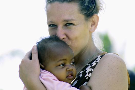Beira,Mozambique-January 10,2010:Swiss woman,Barbara Hofmann,with a small child.Since 1989 after seeing the reality of war,it collects in its structure in Beira,children affected by war,orphaned and abandoned.