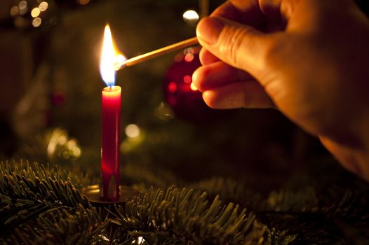 close up of a candle on a christmas tree