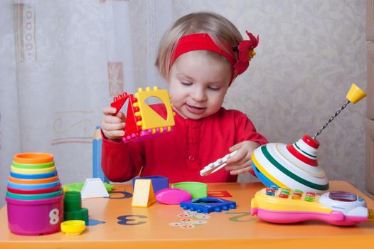 Pretty girl collecting sorter at table in nursery