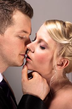 young couple in wedding wear kissing