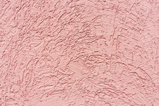 Texture of the worn pink wall with cracks