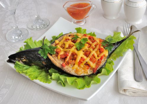 Mackerel stuffed with vegetables and cheese with lettuce