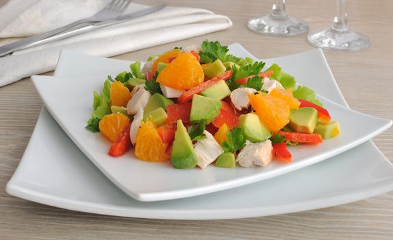 Chicken salad with avocado, sweet pepper and orange