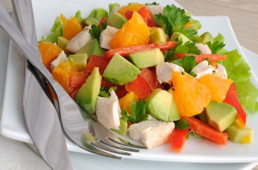 Chicken salad with avocado, sweet pepper and orange