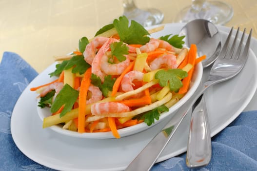 Salad of celery root and leaves with carrots, apples and shrimp