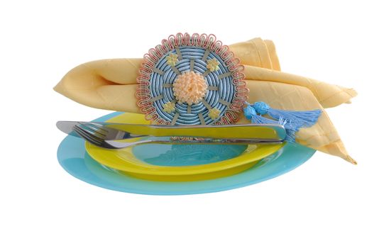 Napkin clamp folded on a plate with knife and fork (isolated)