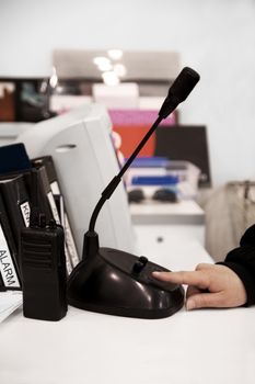 Person at helpdesk using an intercom