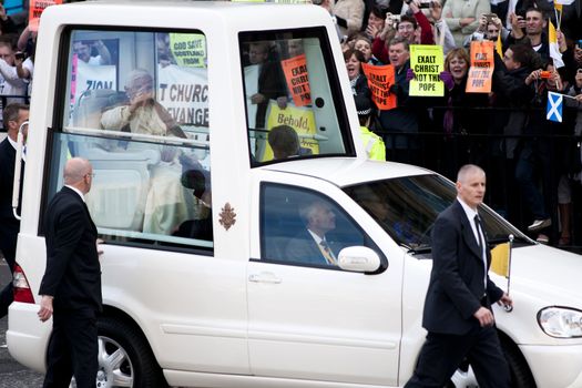 Pope Benedict XVI - Edinburgh, Scotland, UK - 16 September 2010. Protesters in the background.