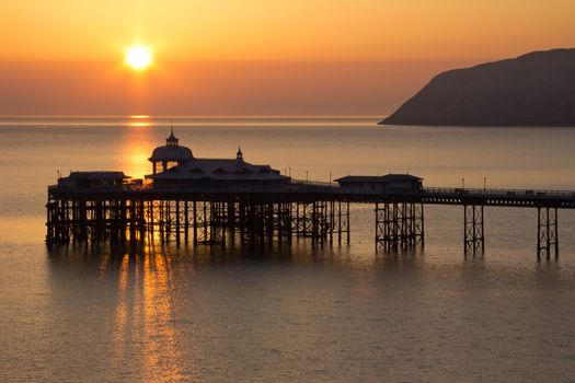 A Golden Sunrise over the Pier in Llandudno Wales