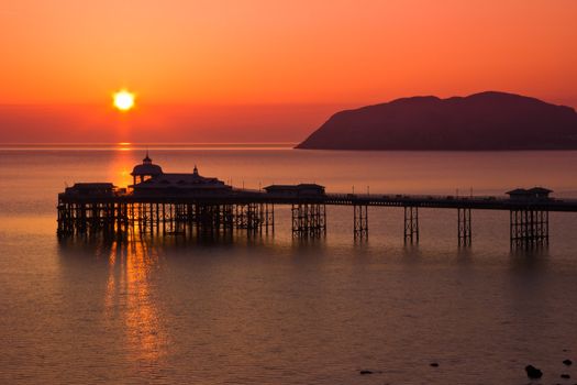 A Beautiful Sunrise over the pier in Llanudno Wales