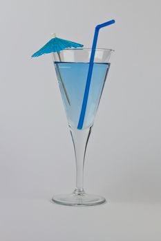 Single Blue Martini cocktail with matching straw and umbrella