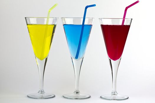 A Trio of Colorful Cocktails with matching straws