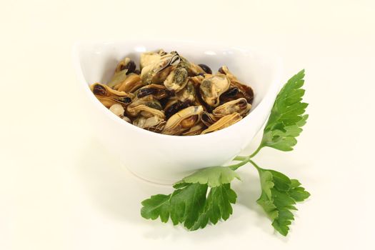 mussels with italian parsley in a bowl on bright background