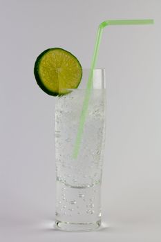 A gin and tonic with ice and lime