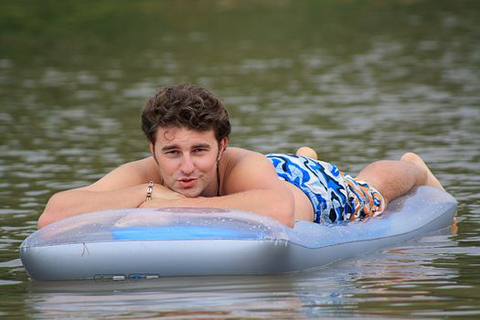 man on the inflatable beach mattress  