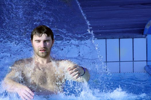 young attractive man relax in spa area