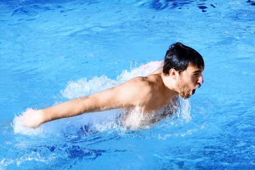 man swims in swimming pool