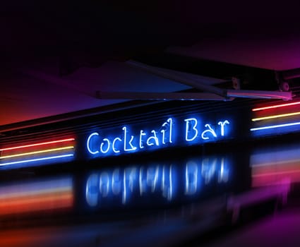 Colorful coctail bar neon sign glowing on dark background