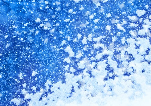 White real snowflakes falling on blue background