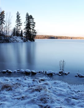 Frozen wilderness lake scenery, blue ice reflection